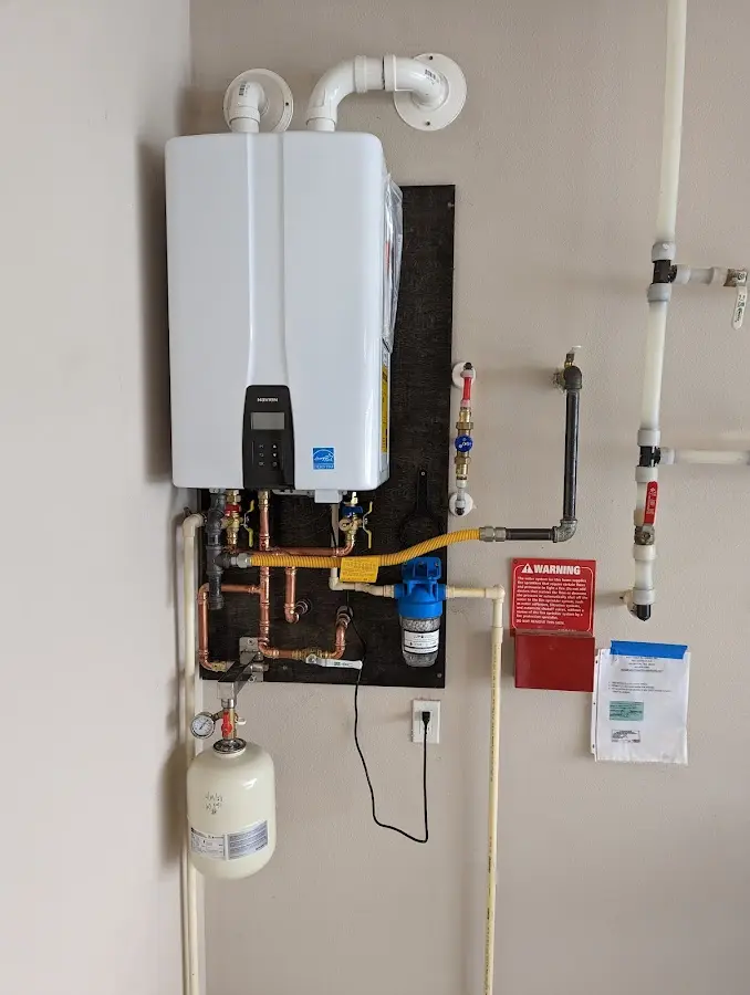 Professional plumber installing copper piping in a Norwich home
